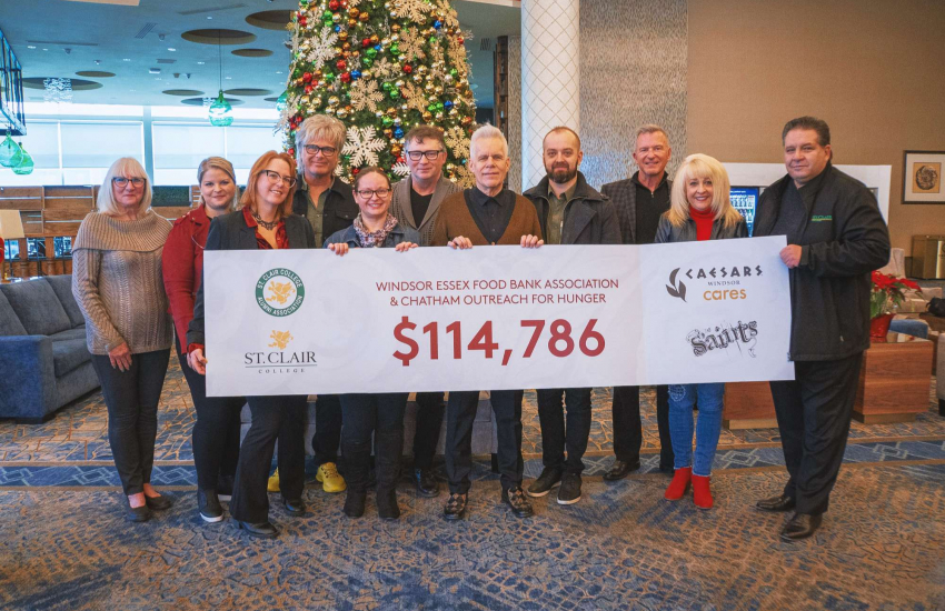 Group photo showcasing the amount of money received from donations ($114,786)